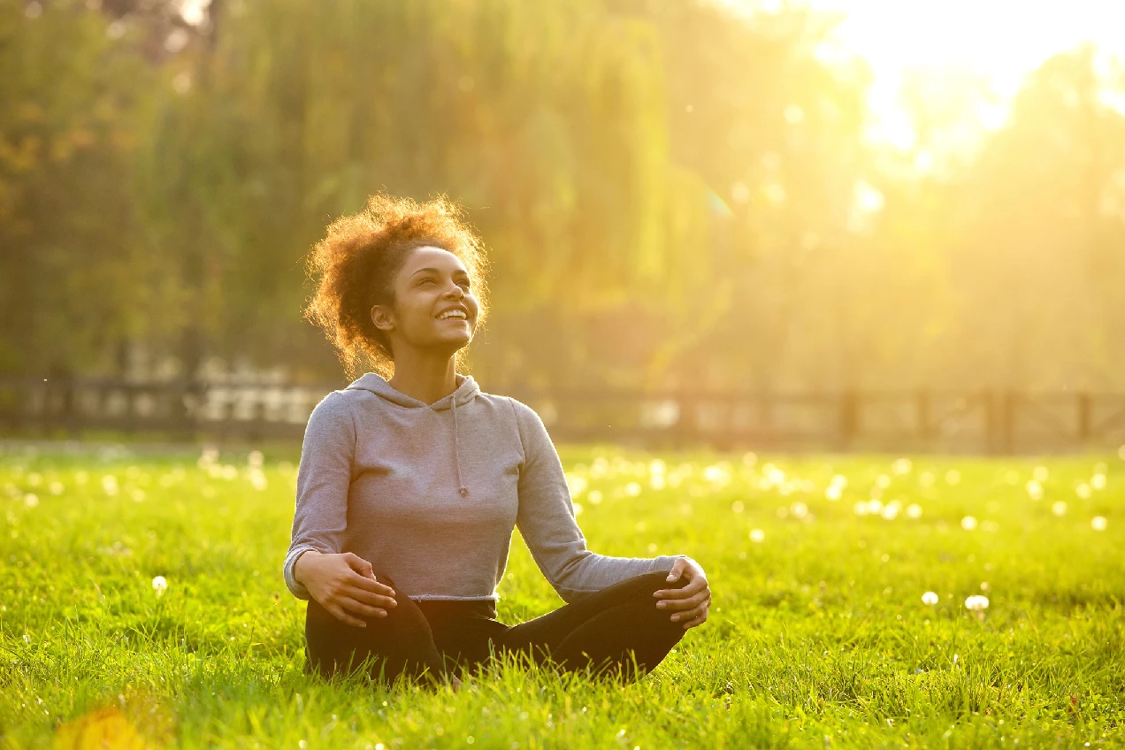 A woman practising calm outdoor breathing and mindfulness